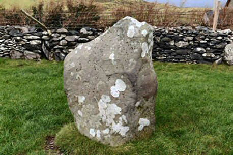 large grey stone in a field